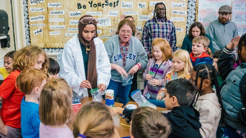 UNCG PhD Chemistry student demonstrates an experiment at the Lindley Elementary Science Night event